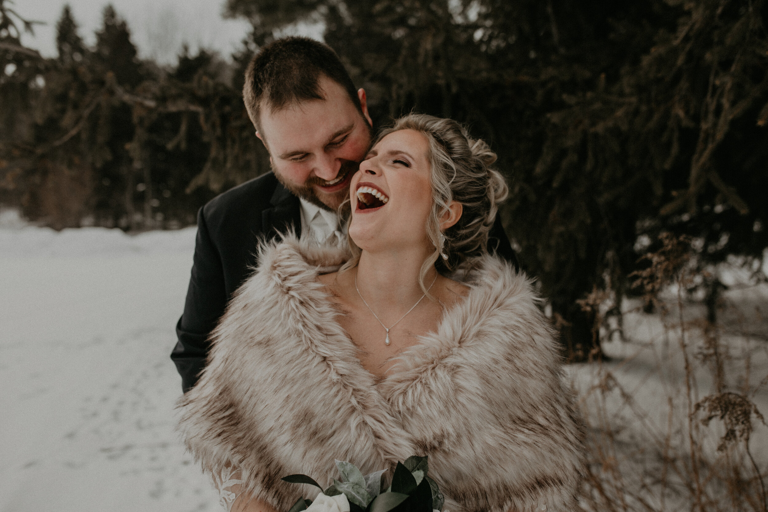  Andrea Wanger Photography cozy winter Wisconsin wedding. Perfect Wisconsin wedding in February. Elegant winter wedding bride and groom photos outside in the snow. 