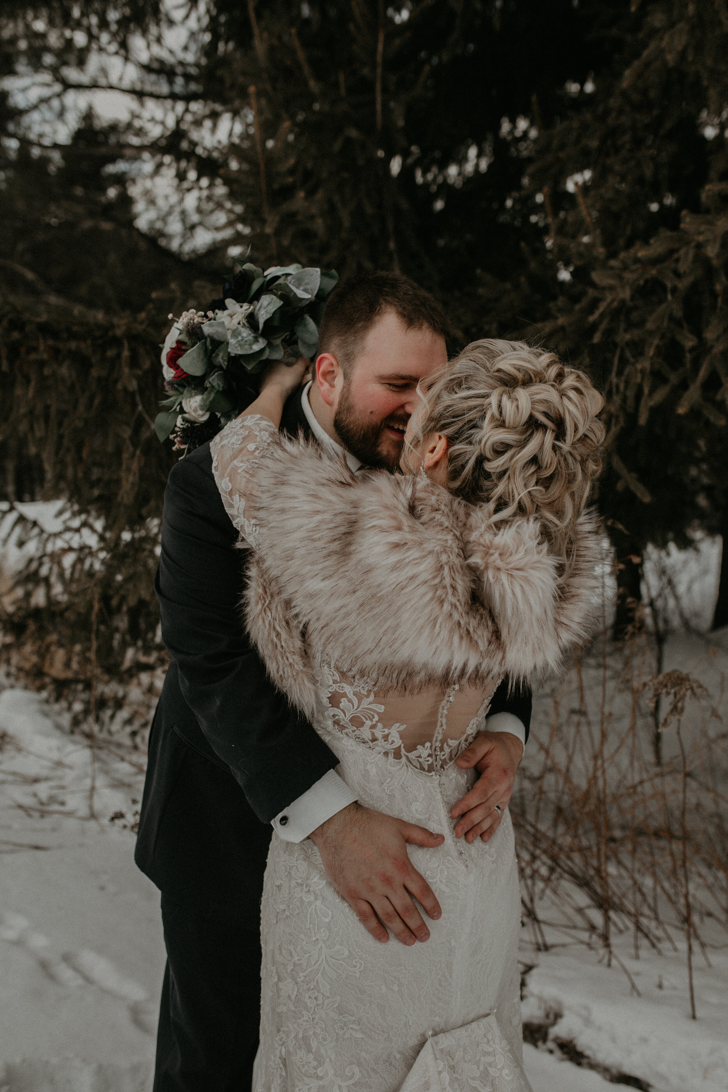  Andrea Wanger Photography cozy winter Wisconsin wedding. Perfect Wisconsin wedding in February. Elegant winter wedding bride and groom photos outside in the snow. 