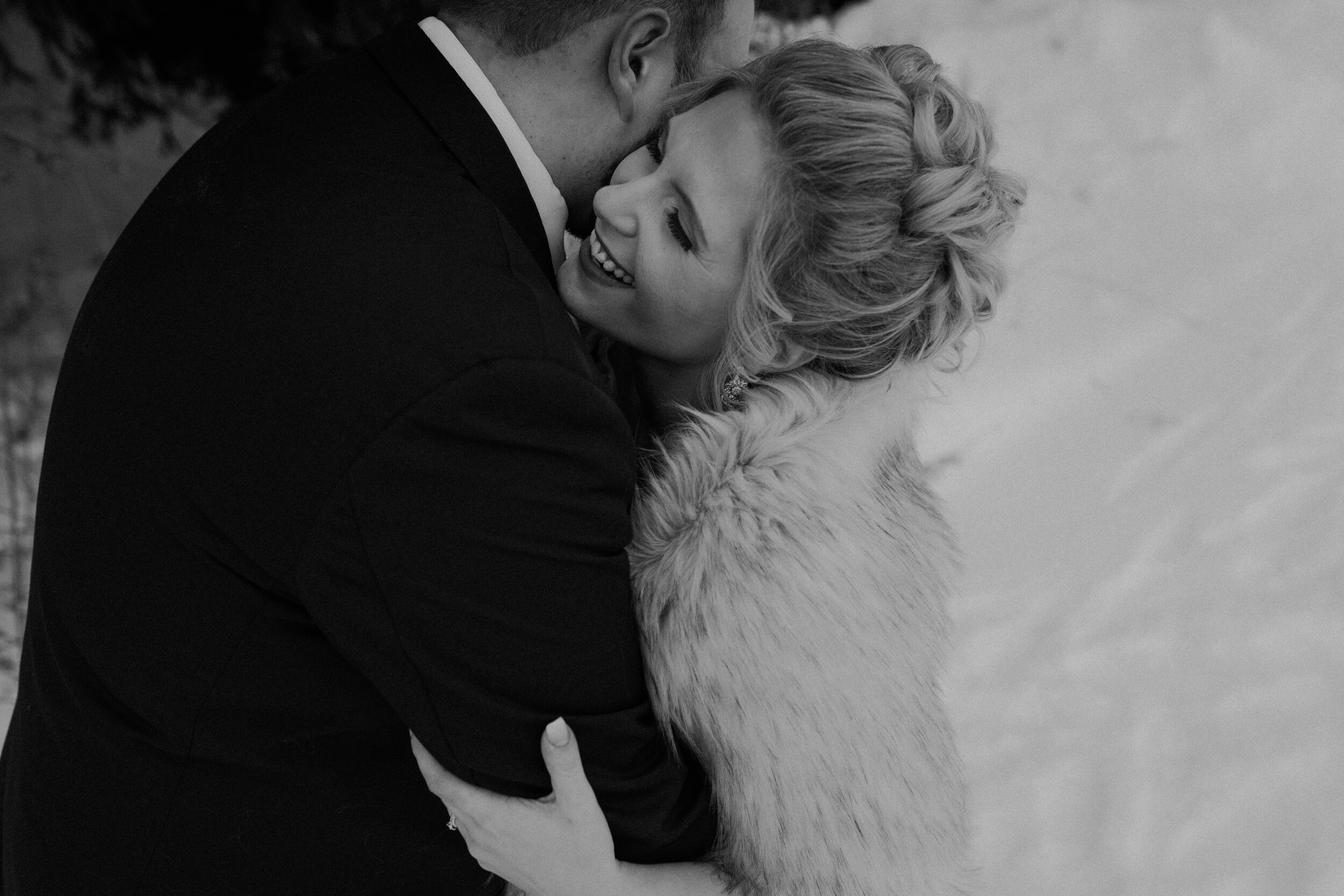  Andrea Wanger Photography cozy winter Wisconsin wedding. Perfect Wisconsin wedding in February. Elegant winter wedding bride and groom photos outside in the snow. Black and white. 