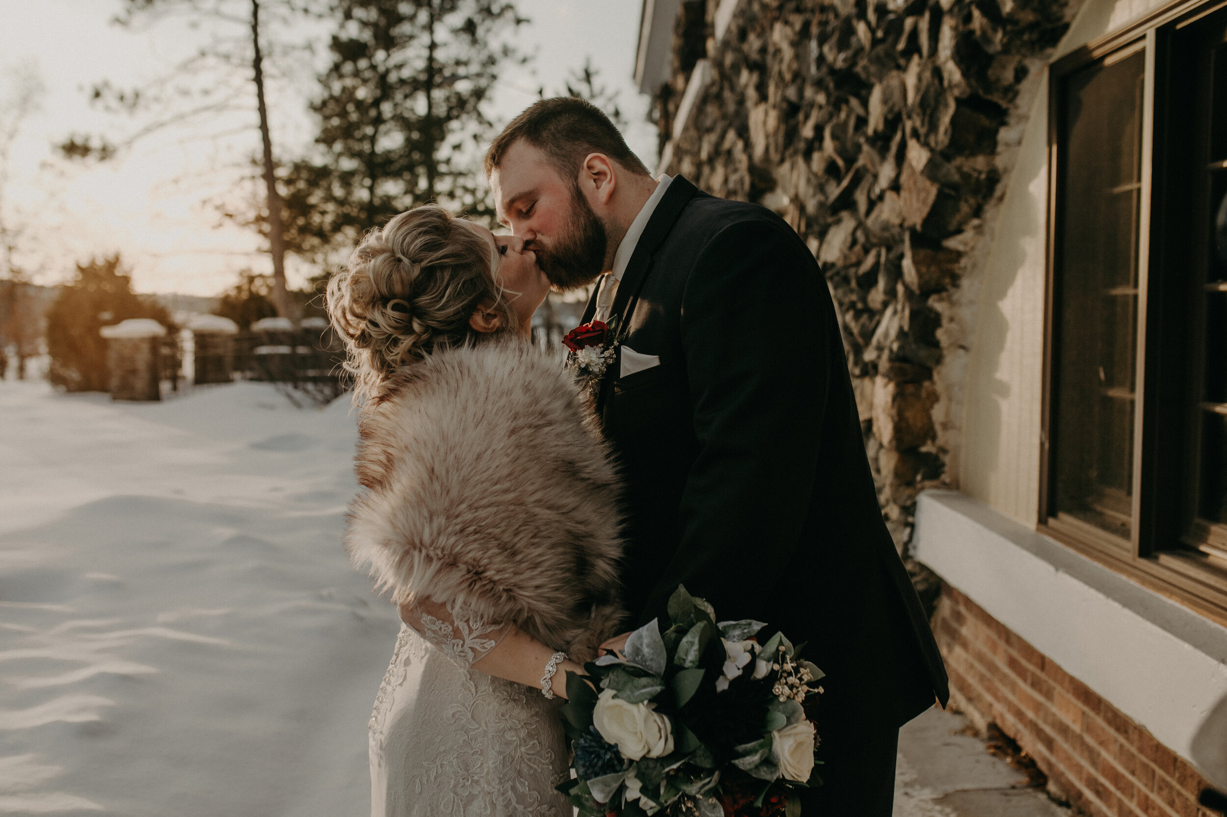  Andrea Wanger Photography cozy winter Wisconsin wedding. Perfect Wisconsin wedding in February. Elegant winter wedding bride and groom photos outside in the snow. Sunset photos. 