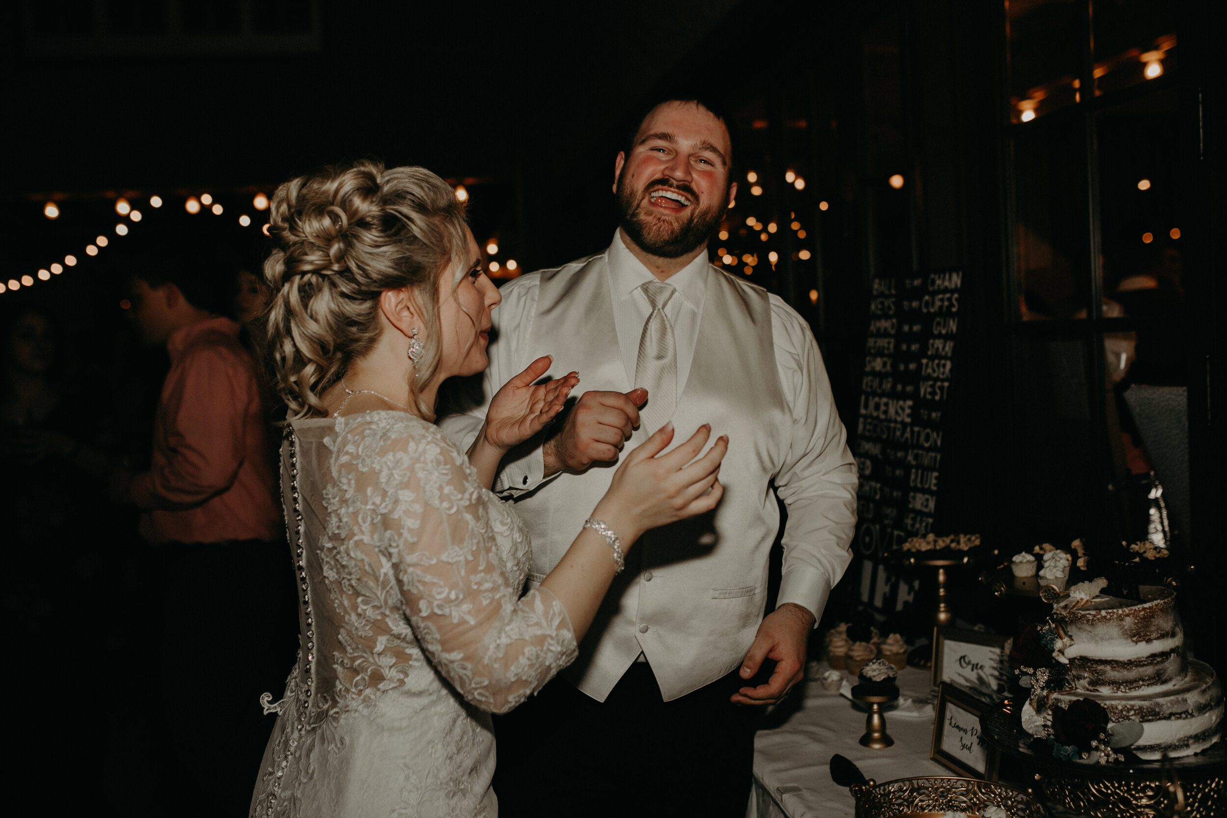  Andrea Wanger Photography cozy winter Wisconsin wedding. Perfect Wisconsin wedding in February. Elegant winter wedding. Reception dessert table. Bride and groom cutting cake. 