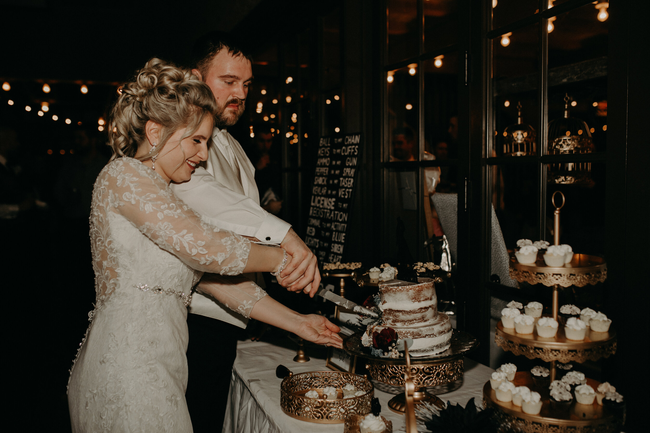  Andrea Wanger Photography cozy winter Wisconsin wedding. Perfect Wisconsin wedding in February. Elegant winter wedding. Reception dessert table. Bride and groom cutting cake. 