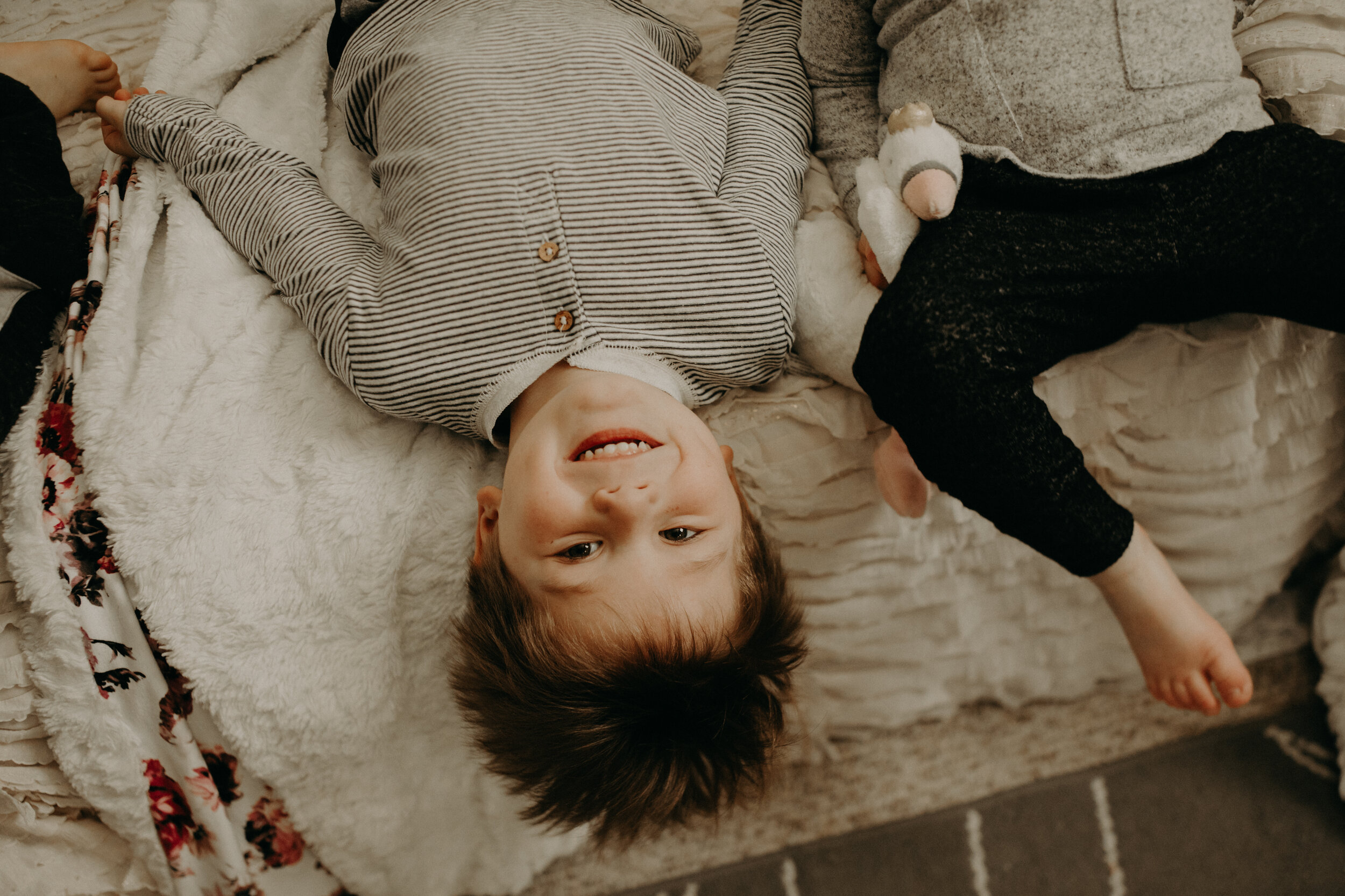  River Falls Family. River Falls Wisconsin. Mother cooking in the kitchen. Lifestyle Newborn Photo session. Wisconsin Newborn Photographer. Wisconsin Lifestyle Newborn Photographer. Lifestyle Newborn In Home Session. Beautiful mom in white making cho