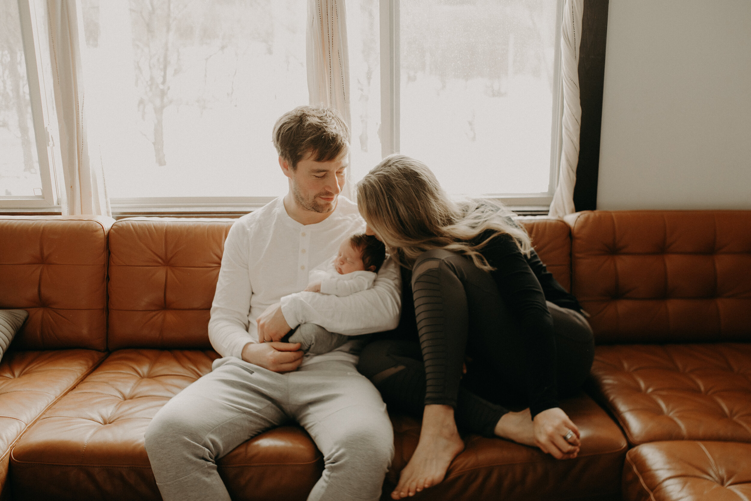  River Falls Family. River Falls Wisconsin. Mother cooking in the kitchen. Lifestyle Newborn Photo session. Wisconsin Newborn Photographer. Wisconsin Lifestyle Newborn Photographer. Lifestyle Newborn In Home Session. Beautiful mom in white making cho