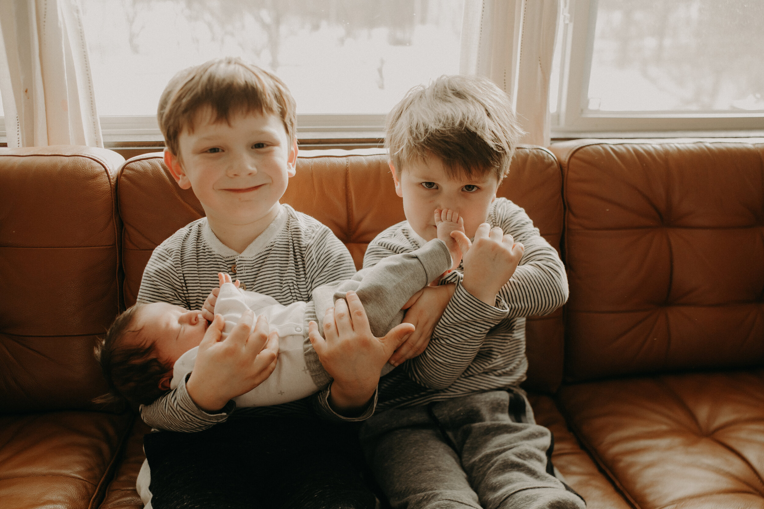  River Falls Family. River Falls Wisconsin. Mother cooking in the kitchen. Lifestyle Newborn Photo session. Wisconsin Newborn Photographer. Wisconsin Lifestyle Newborn Photographer. Lifestyle Newborn In Home Session. Beautiful mom in white making cho