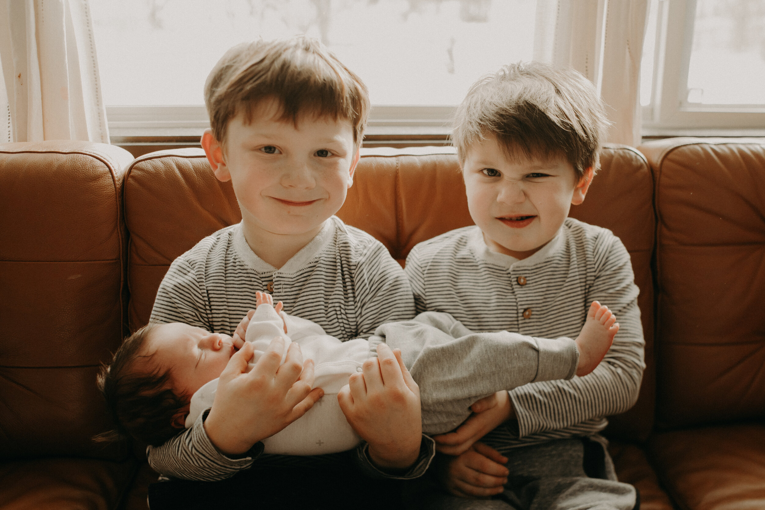  River Falls Family. River Falls Wisconsin. Mother cooking in the kitchen. Lifestyle Newborn Photo session. Wisconsin Newborn Photographer. Wisconsin Lifestyle Newborn Photographer. Lifestyle Newborn In Home Session. Beautiful mom in white making cho