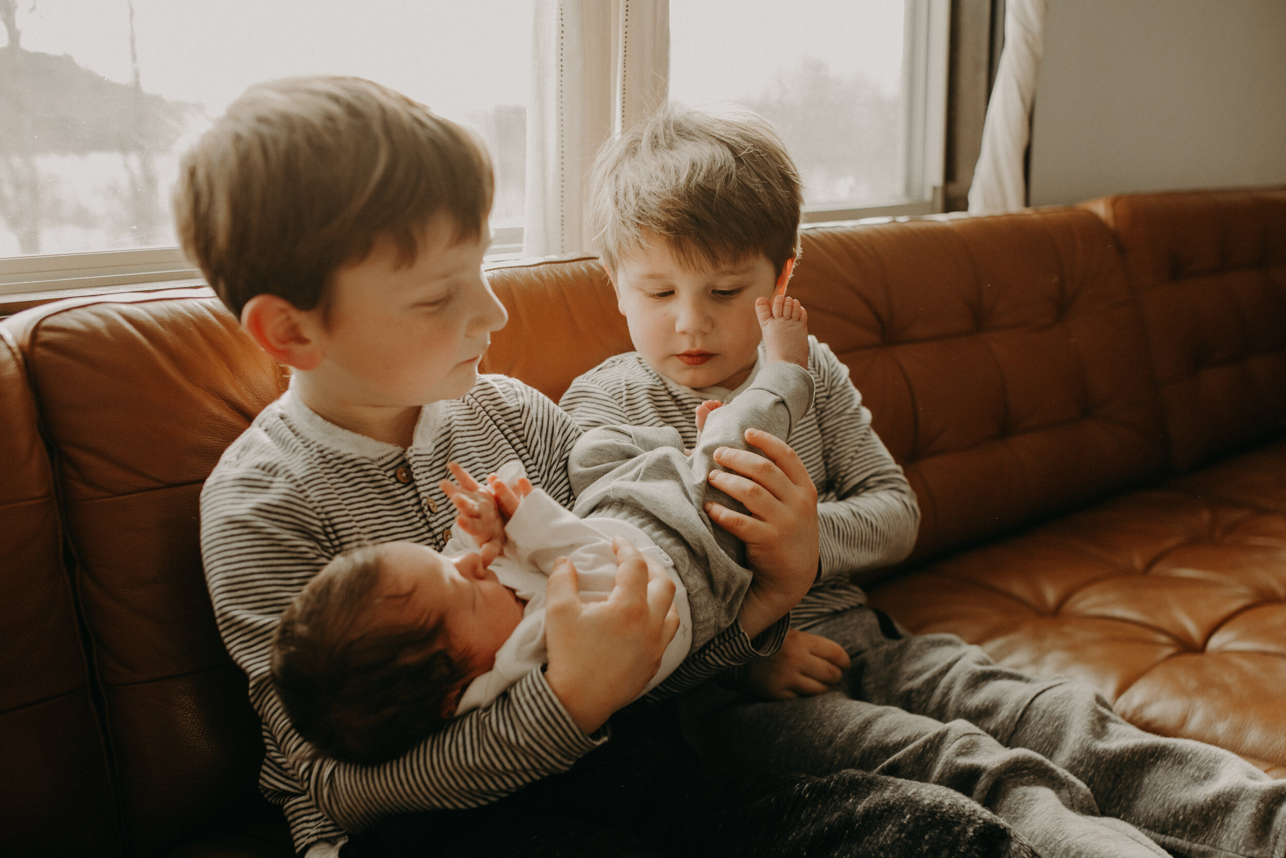  River Falls Family. River Falls Wisconsin. Mother cooking in the kitchen. Lifestyle Newborn Photo session. Wisconsin Newborn Photographer. Wisconsin Lifestyle Newborn Photographer. Lifestyle Newborn In Home Session. Beautiful mom in white making cho