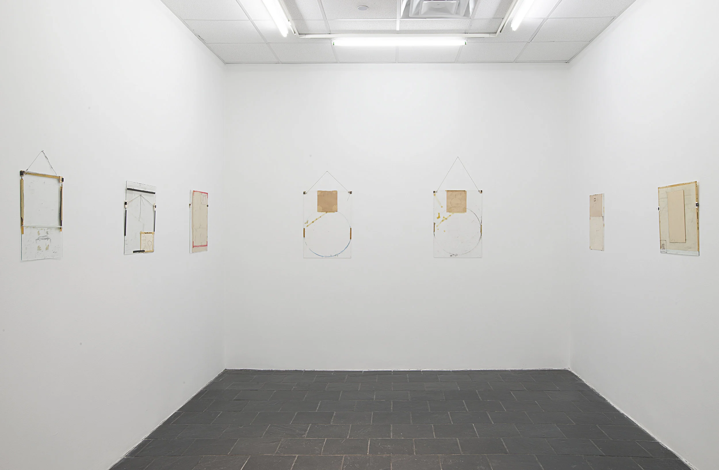 Installation view: Nahum Tevet: Works on Glass, 1972–1975 , Hunter College Art Galleries, 2016. Photo by Bill Orcutt. Left to right: Untitled #14, 1974; Untitled #29, 1975; Untitled #33, 1975; Untitled #30, 1975; Untitled #32, 1975; Untitled #36, 1975; Untitled #24, 1975. 