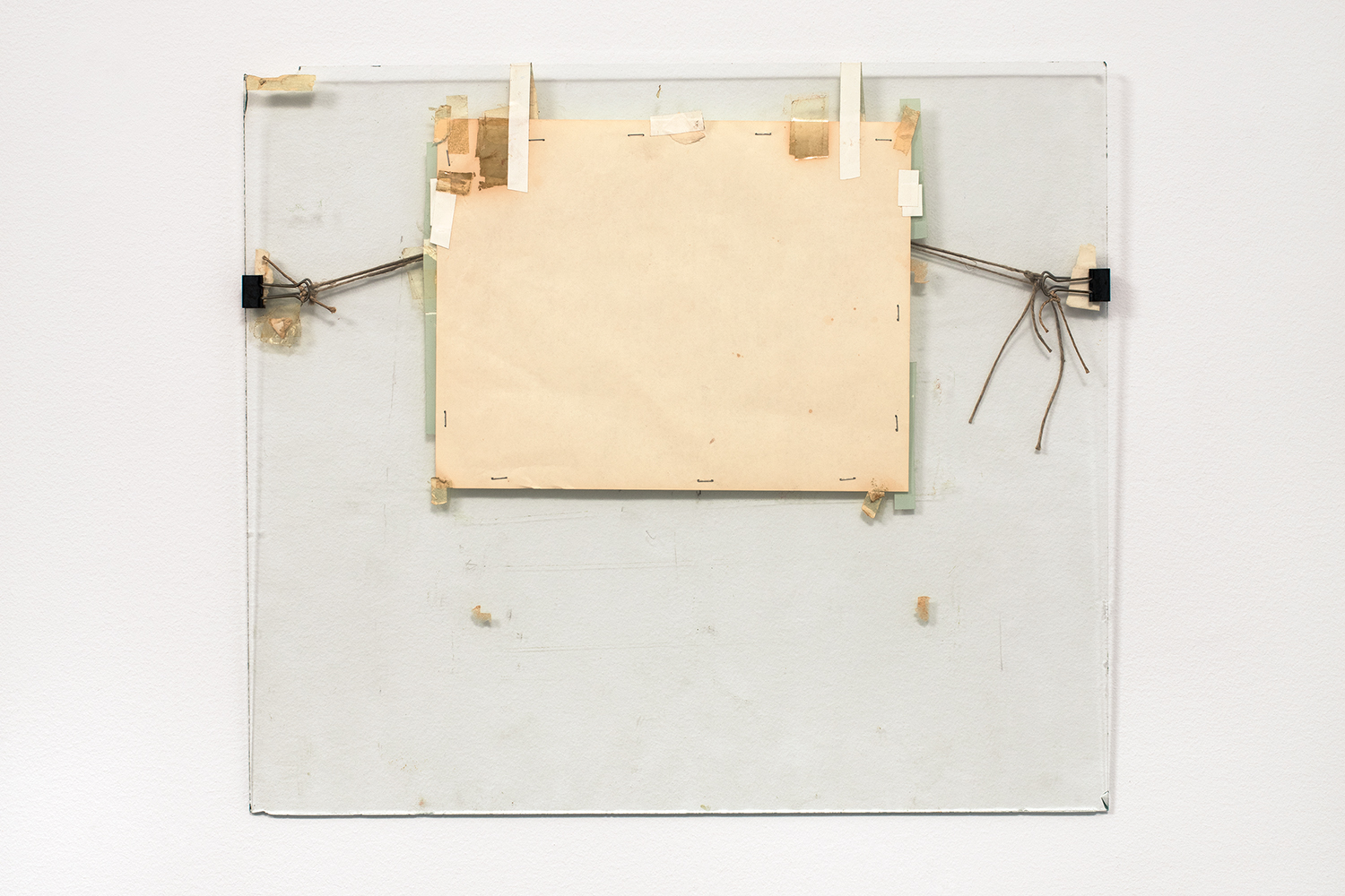  Nahum Tevet, Untitled #5, 1972. Paper, binder clips, twine, staples, plastic tape, masking tape, transparent tape, and wax pencil on glass, 17 3/16 x 19 3/4 x 7/16 in. (43.7 x 50.2 x 1.1 cm). Collection of the artist. Photo by Polite Photographic, c