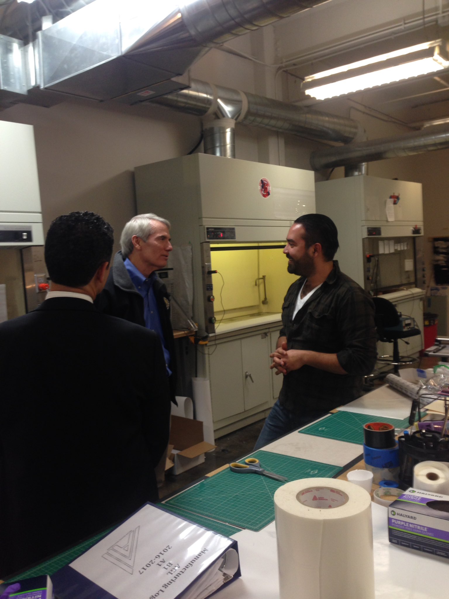 Ali Blandon explaining dry adhesion and electrospinning to Senator Rob Portman and Akron Accelerator CEO Anthony Margida.