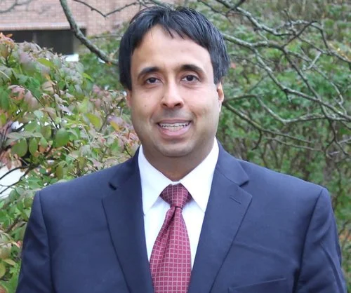 Herman Dhade, Attorney at law, Licensed in both Canada and the US, President of Dhade & Associates, PC