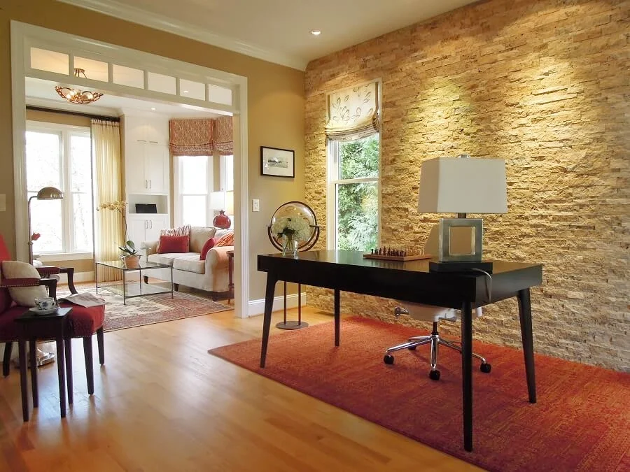 An accent wall of stacked travertine stone adds sparkle and texture to this gorgeous home office in Chapel Hill, NC.
