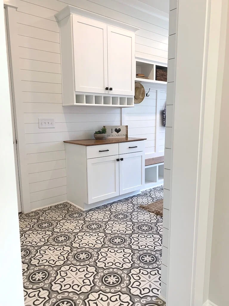 Bold tile floor, clean, white shiplap and lots of storage are excellent ideas for Mudrooms.