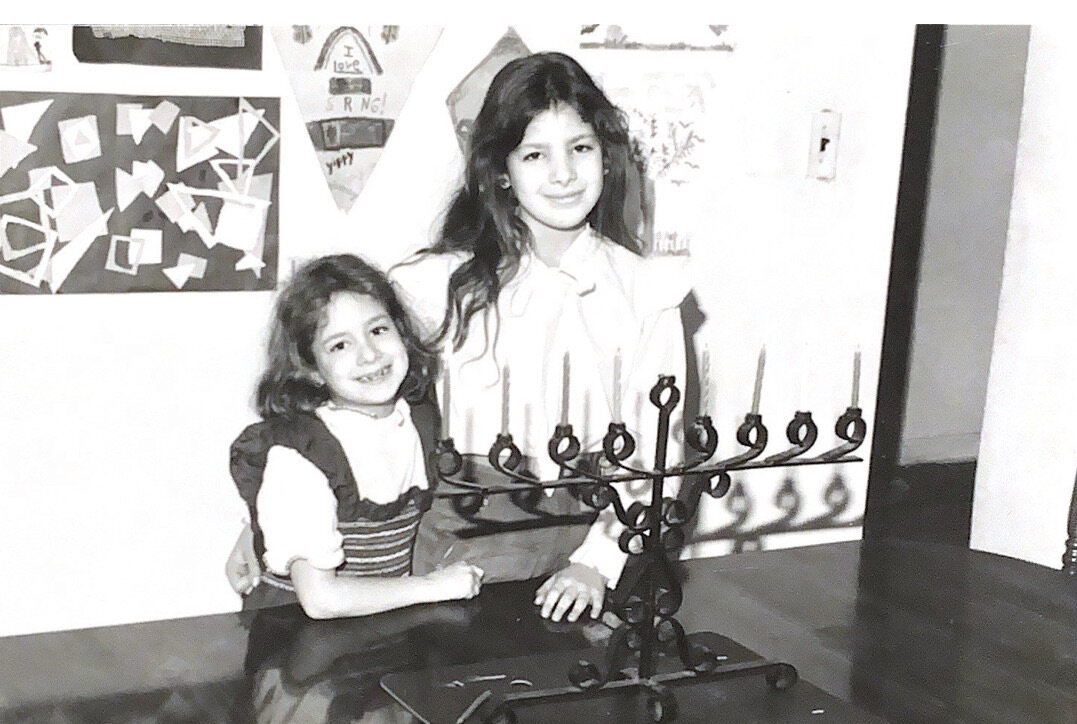 My sister and me posing in Flushing, Queens with the Hanukkiah my father made in Israel.jpeg