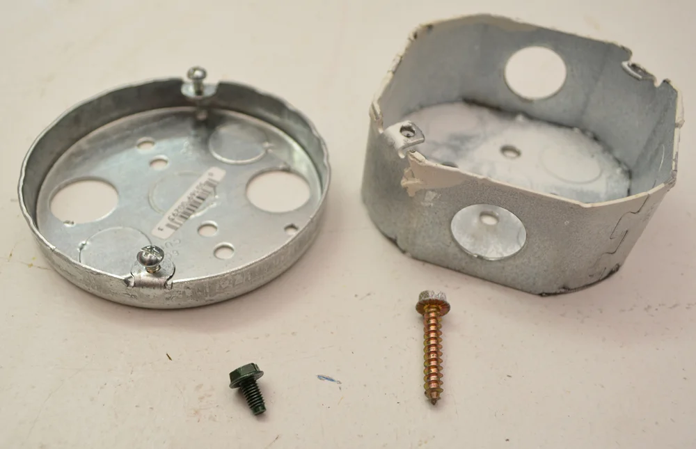 From Left: A Proper Grounding Screw and an Idiot's Coarse-Threaded Grounding Screw (attempt)
