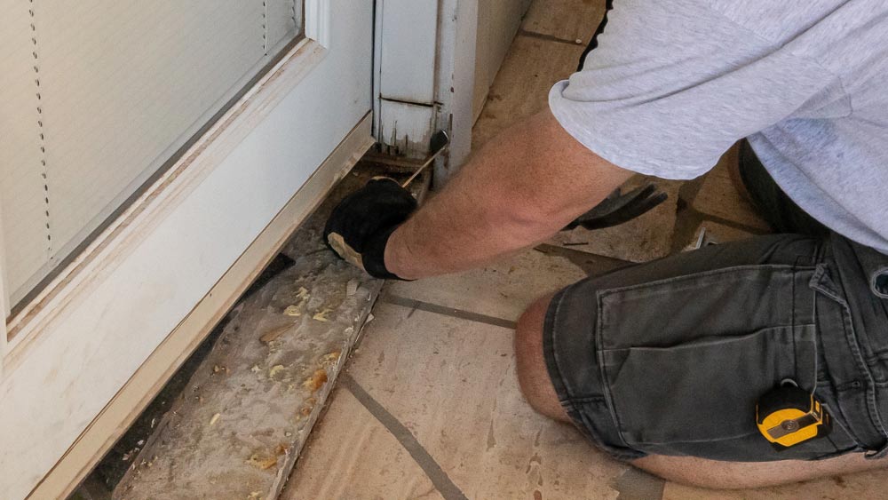 The French patio door installed at my house was too small for the rough  opening, so there is a gap between the concrete slab and threshold of about  1.5”. What is the