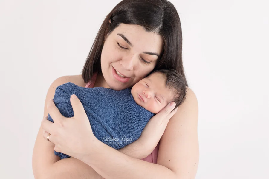Do you see that little baby smile? I think he loves being in mommy's arms.