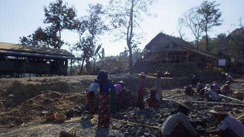 The villagers lay broken rocks between strings