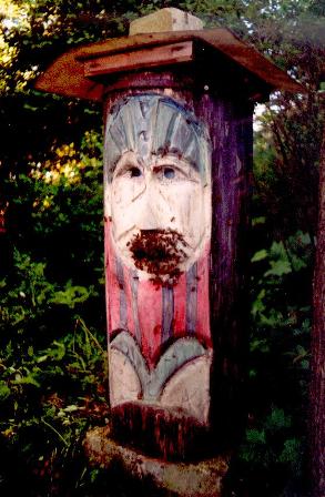 A carved Klotzbeute – the face is meant to keep away spirits and enemies who steal the honey from the hive.