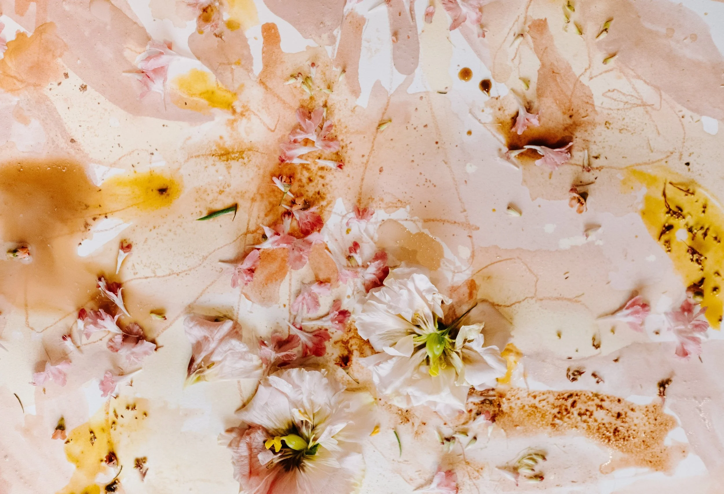 Abstract artwork featuring pink and white flowers on a mixed media background with watercolor and ink splatters.