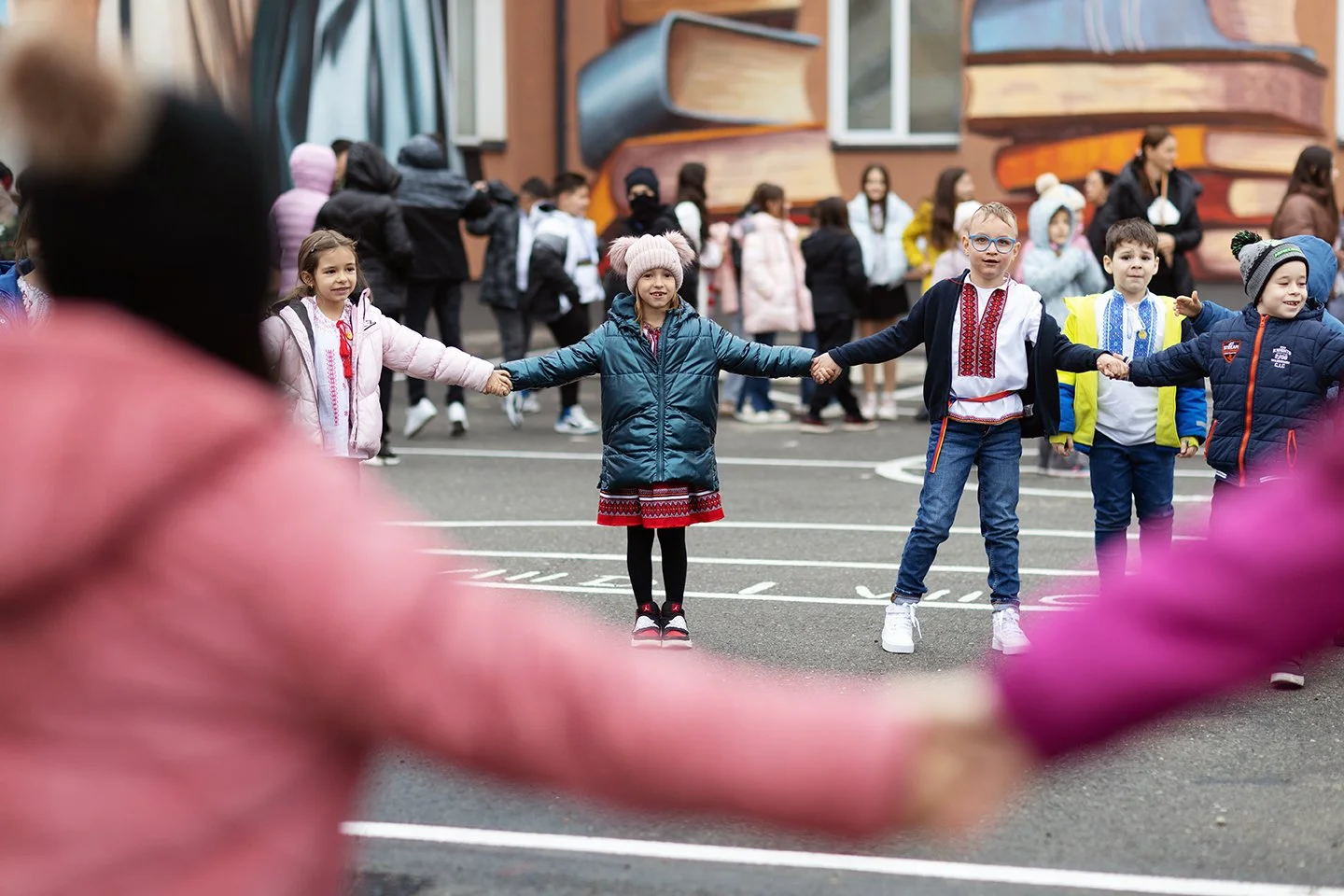 andy-bate-reportage-romania-ebrd-happy-children-holding-hands-playground-02.jpg