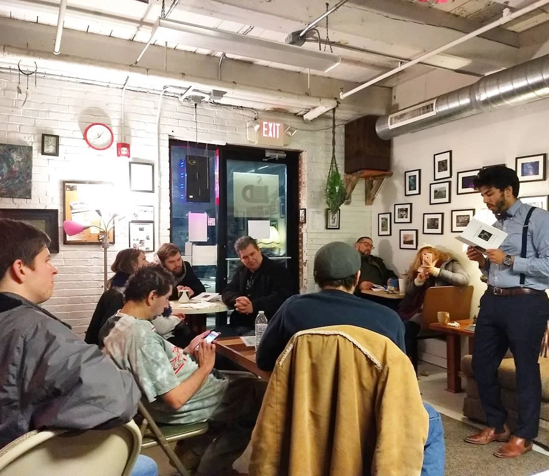 Justin (far right) reads to guests at Coffee House Without Limits in Allentown, PA