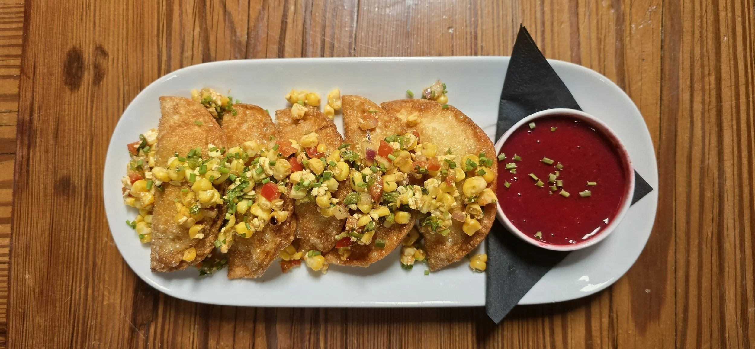 Summer duck multaschen dumplings with corn relish and cherry dijon sauce.