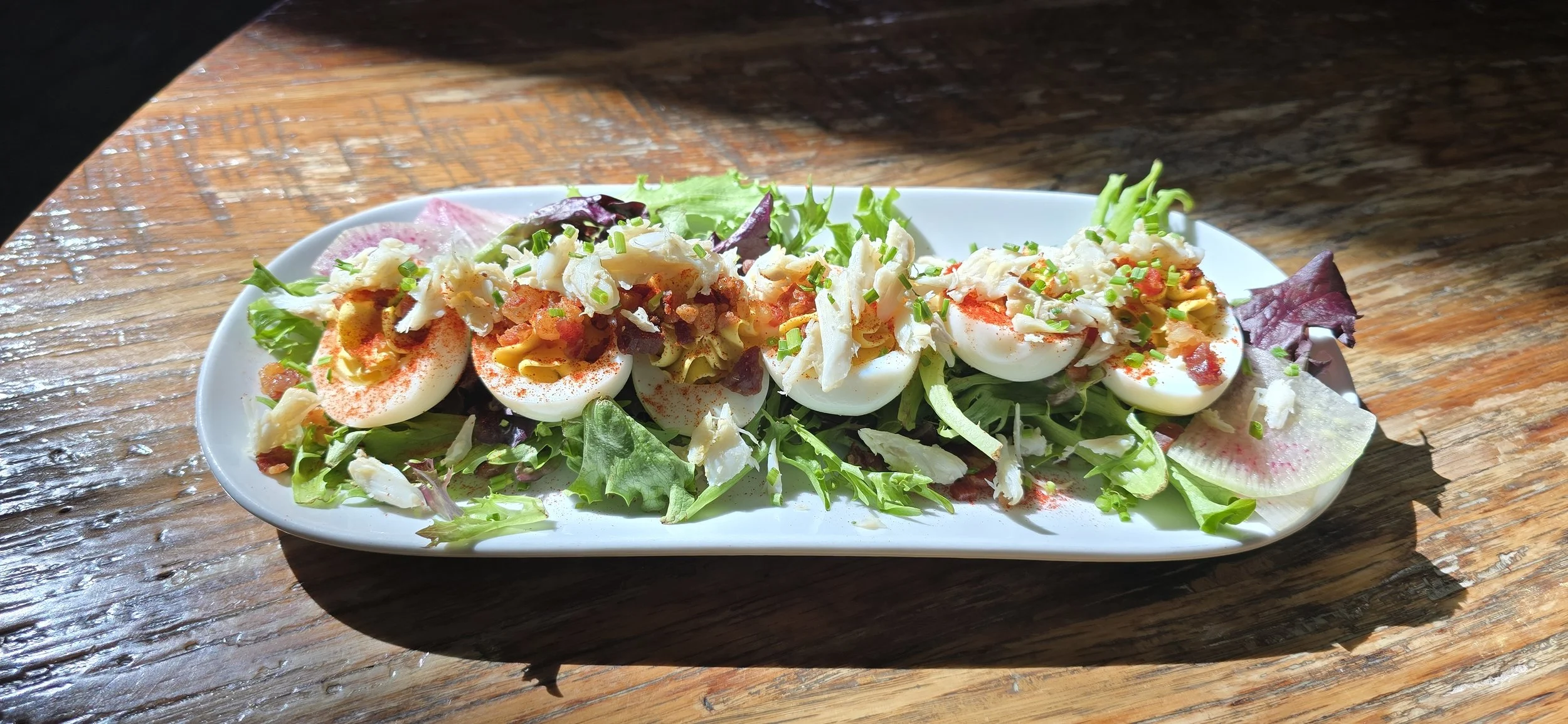 Deviled eggs topped with crab and old bay.