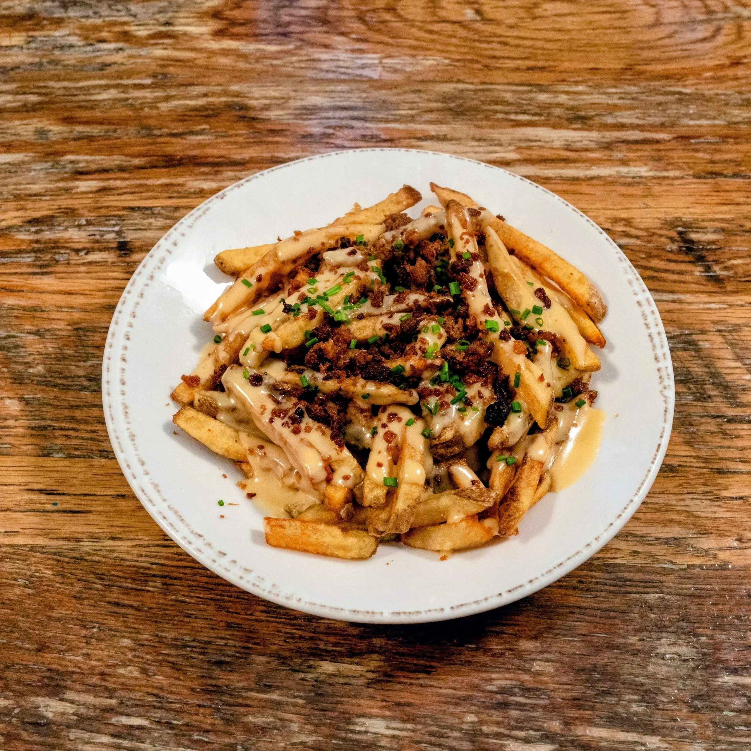 Inn-made frittes topped with bier cheese and bacon crumble.