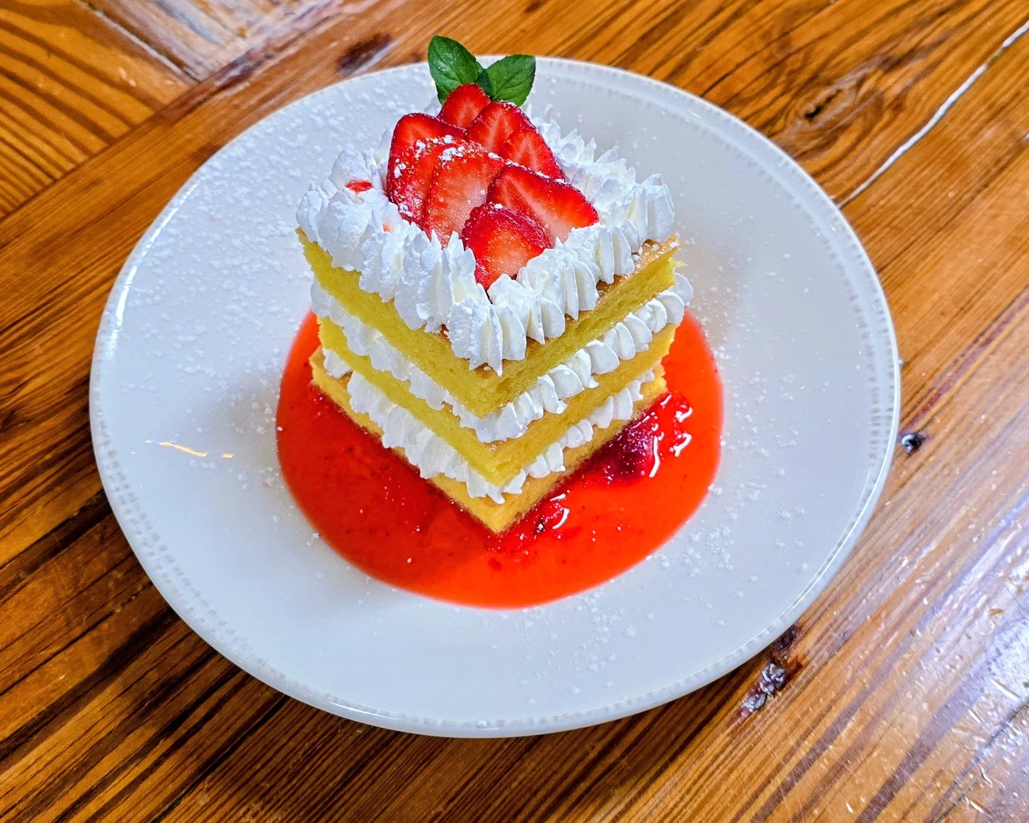 Strawberry Lemon Cake with two layers of lemon curd and whipped cream, macerate strawberry sauce.