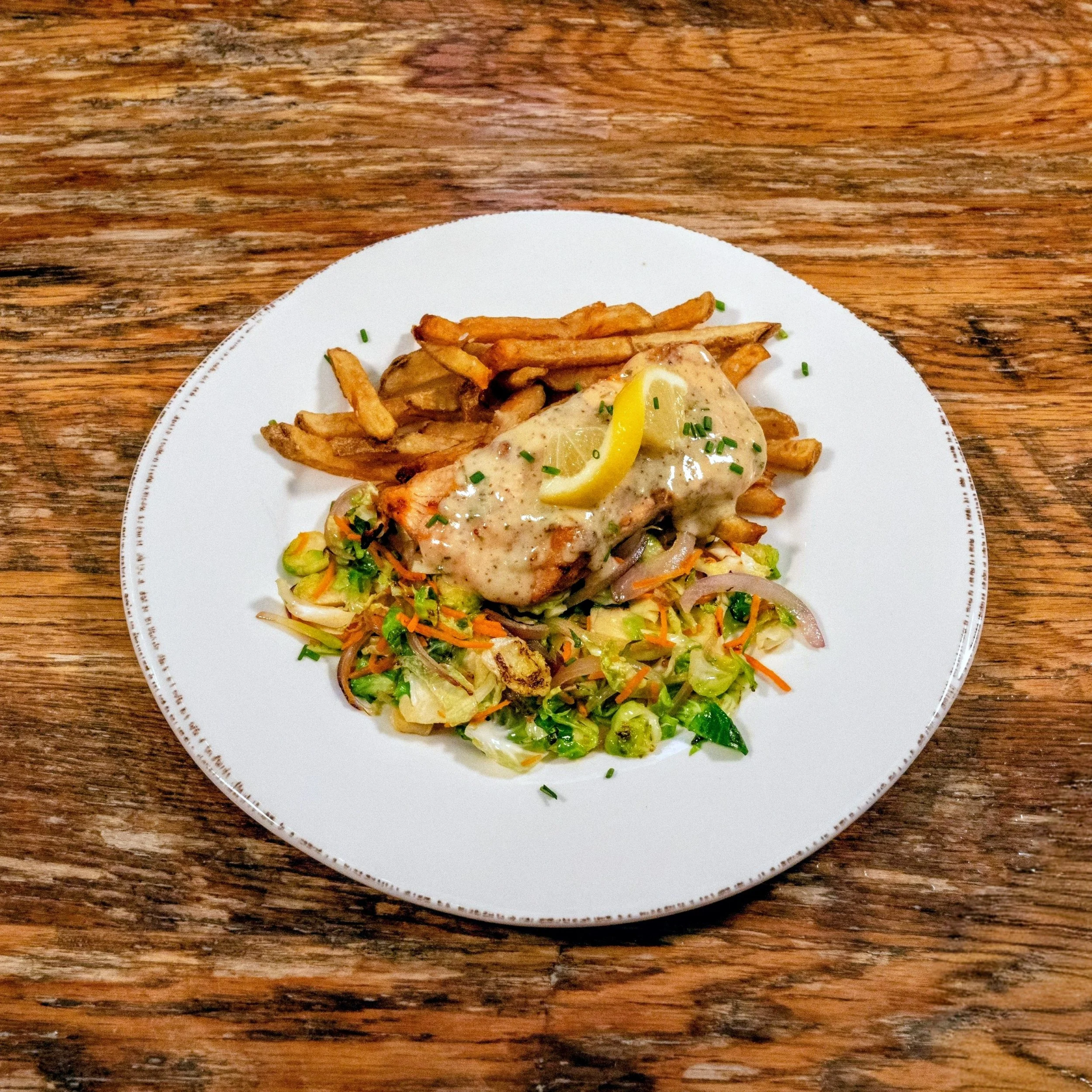 Mustard glazed Salmon with mixed vegetables and frites.