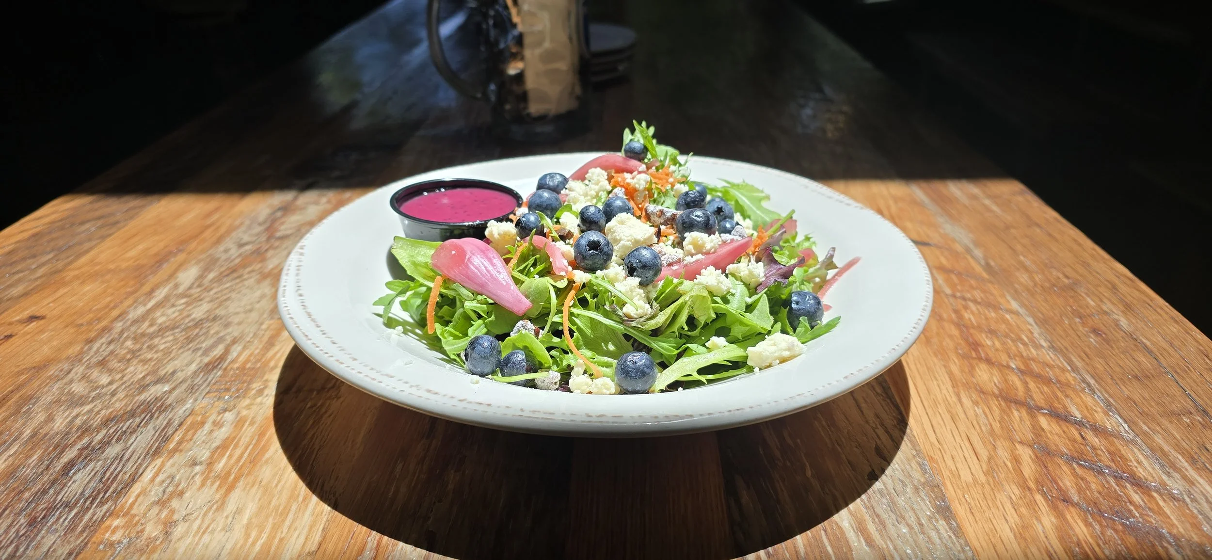 Blueberry feta salad with pickled onions, mixed greens, feta, blueberry poppyseed vinaigrette.