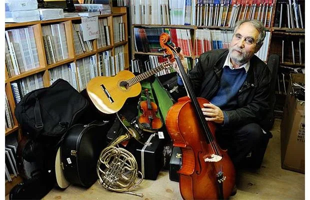 Janos Maté shows some of the donated instruments at Tapestry Music that will be sent to Paraguay’s Recycled Orchestra. Photograph by Dan Toulgoet, Vancouver Courier