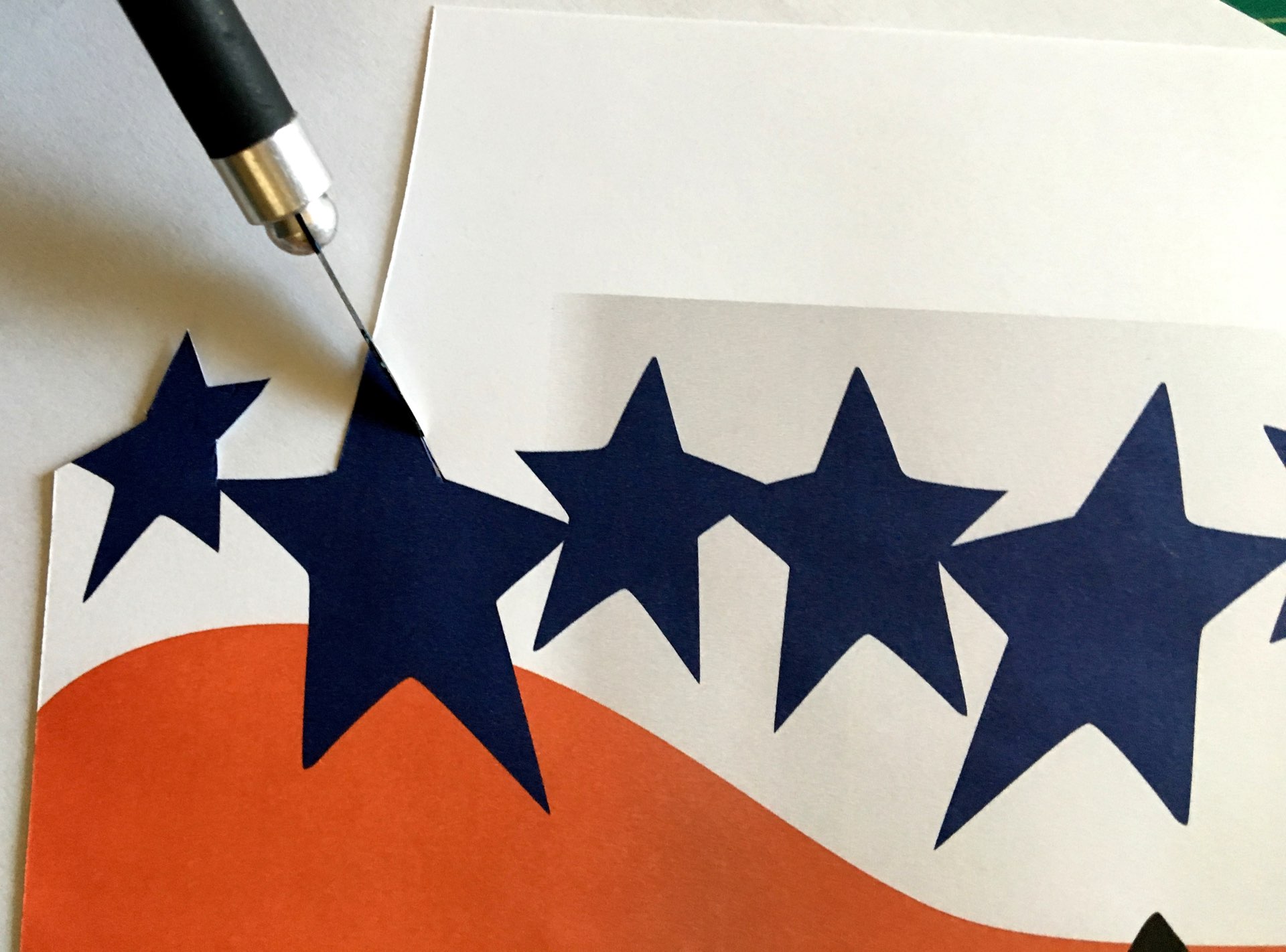 step 3 - With scissors or a craft knife, cut the excess margin away from the top of the stars to create a die cut edge against the stencil blank (step 4).