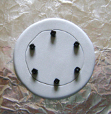 step 5 - Place six beads equal distance apart around the inside of the circle. Press the beads into the clay. The bead holes should be large enough to accommodate the 18 gauge wire.