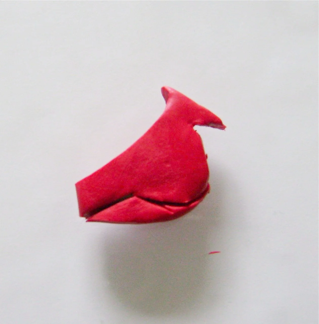 step 4 - Cut from the inside edge of the bottom slit in a curve shape with the craft knife to form the body.