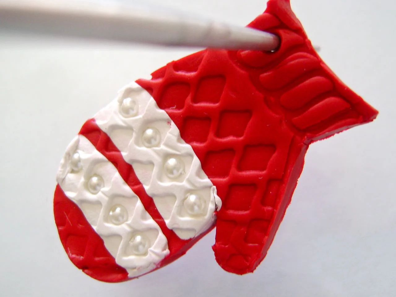 step 7 - Use an Etch n' Pearl tool to make a small hole in the upper corner of each mitten for the yarn hanger.