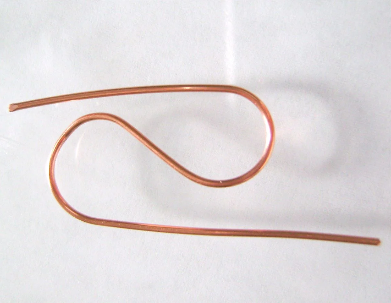 step 8 - Cut another piece of wire about 3” long. Create the decorative “S” shape wire by wrapping one half of the wire around a marker in one direction and the other half in the opposite direction. Cut off the excess and curl the ends.