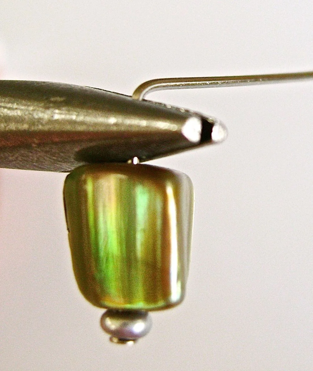 step 2 - Create a 90 degree bend in the wire by pushing against the pliers with your finger.