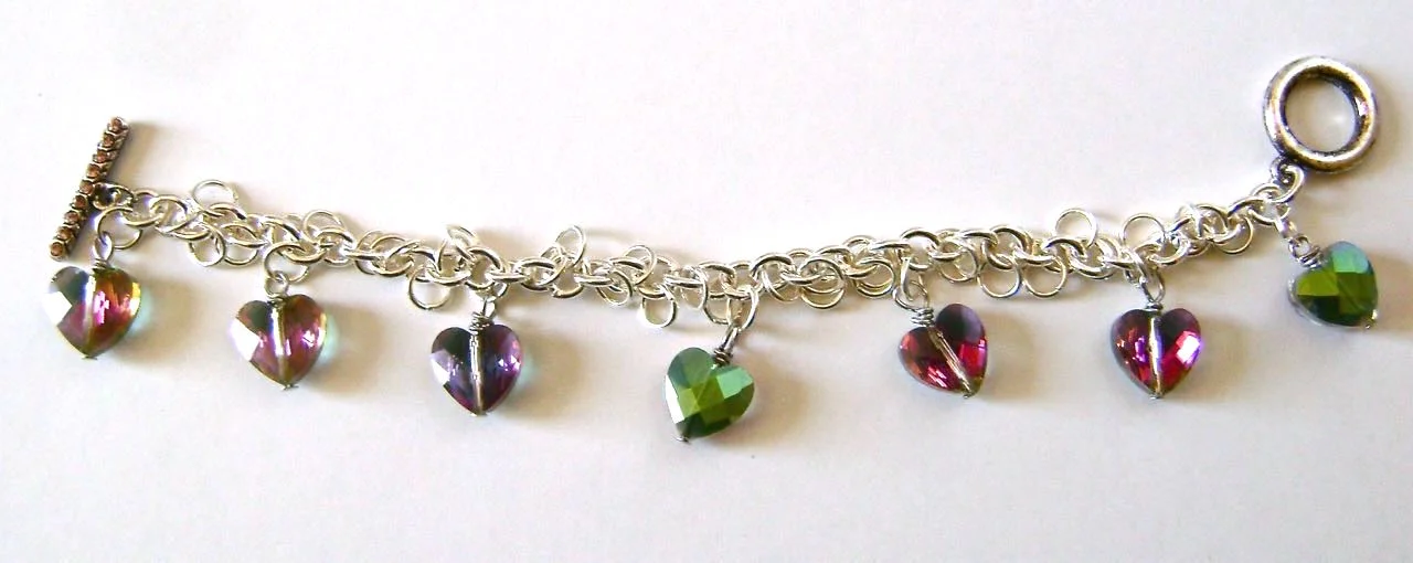 step 16 - Attach the seven crystal hearts to a jump ring on the chain leaving approximately .75” between each.