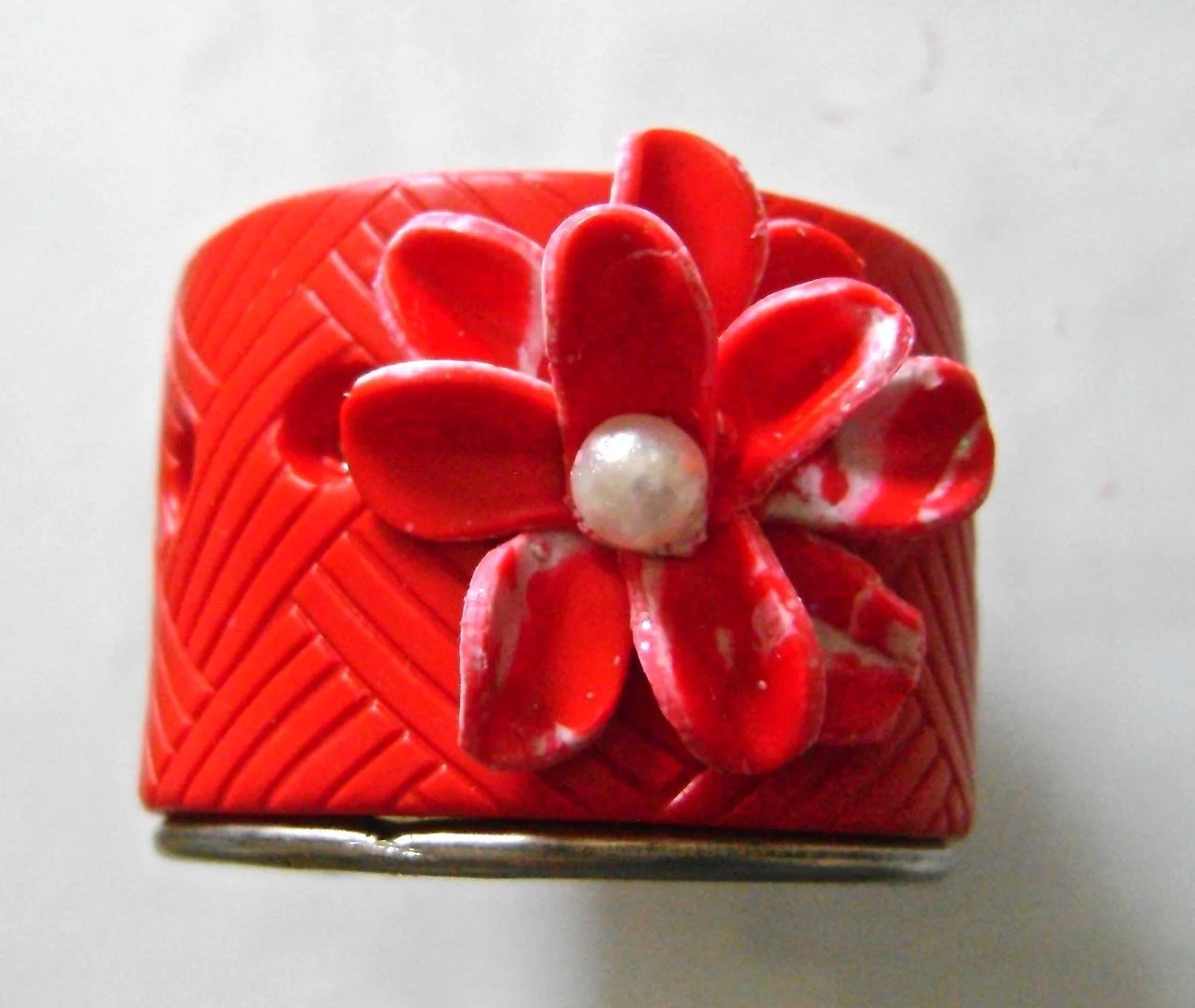 step 11 - Press a pearl into the center of the flower to embed it into the clay.