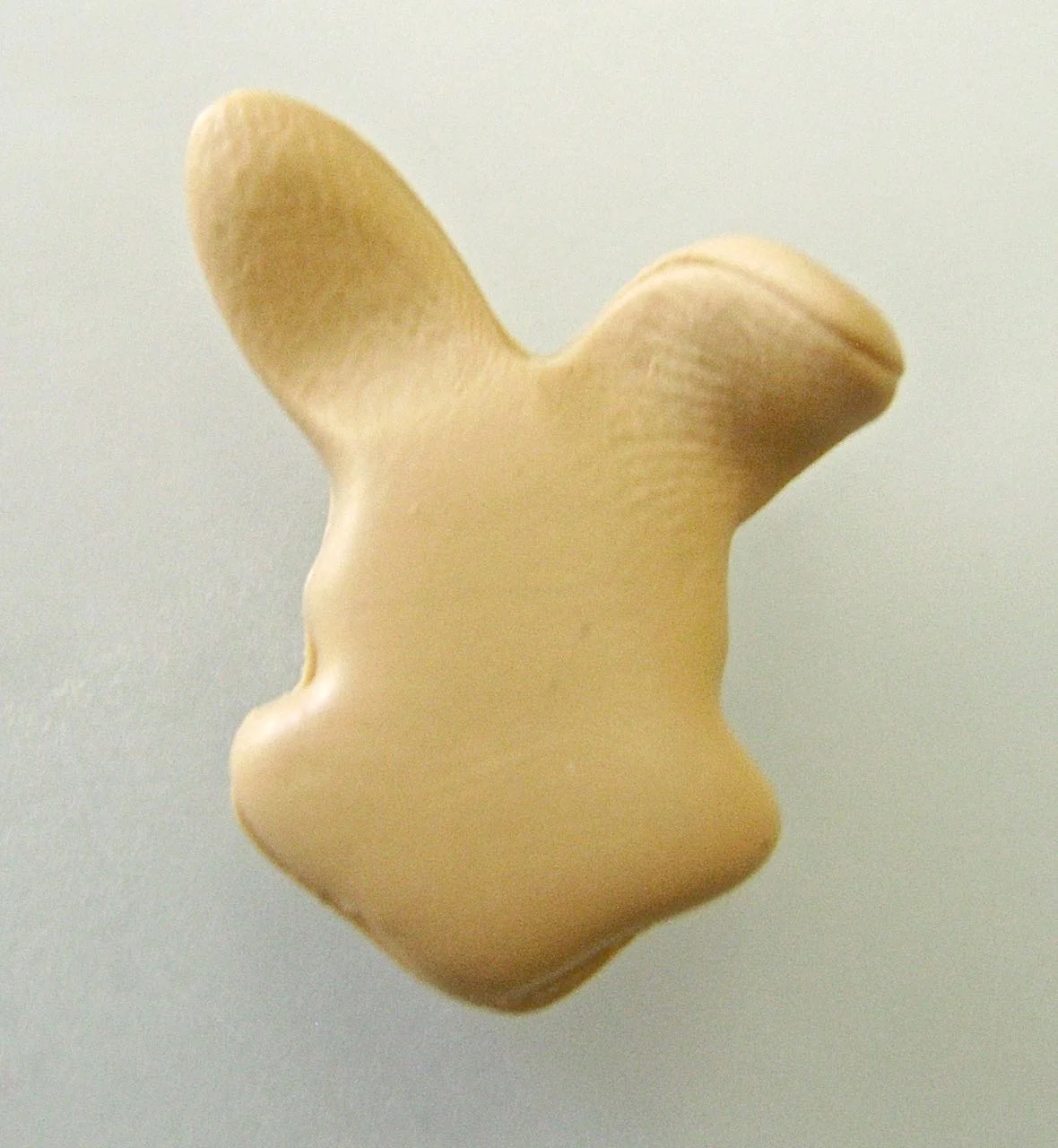 step 7 - Pinch the bunny ears with your fingers to flatten them and turn them downward.