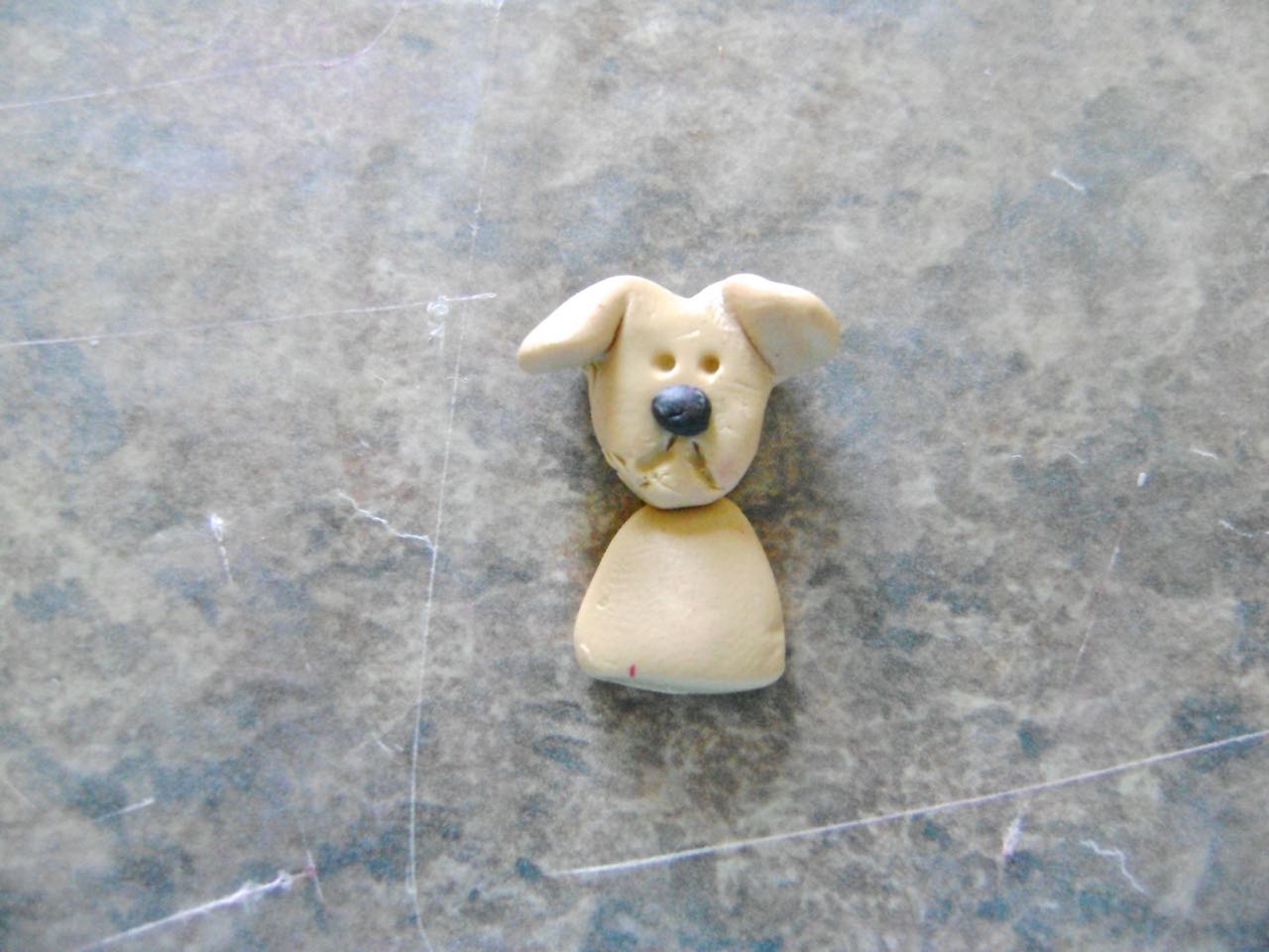 step 9 - Roll a glob of clay to create a small half body and press the head onto it.