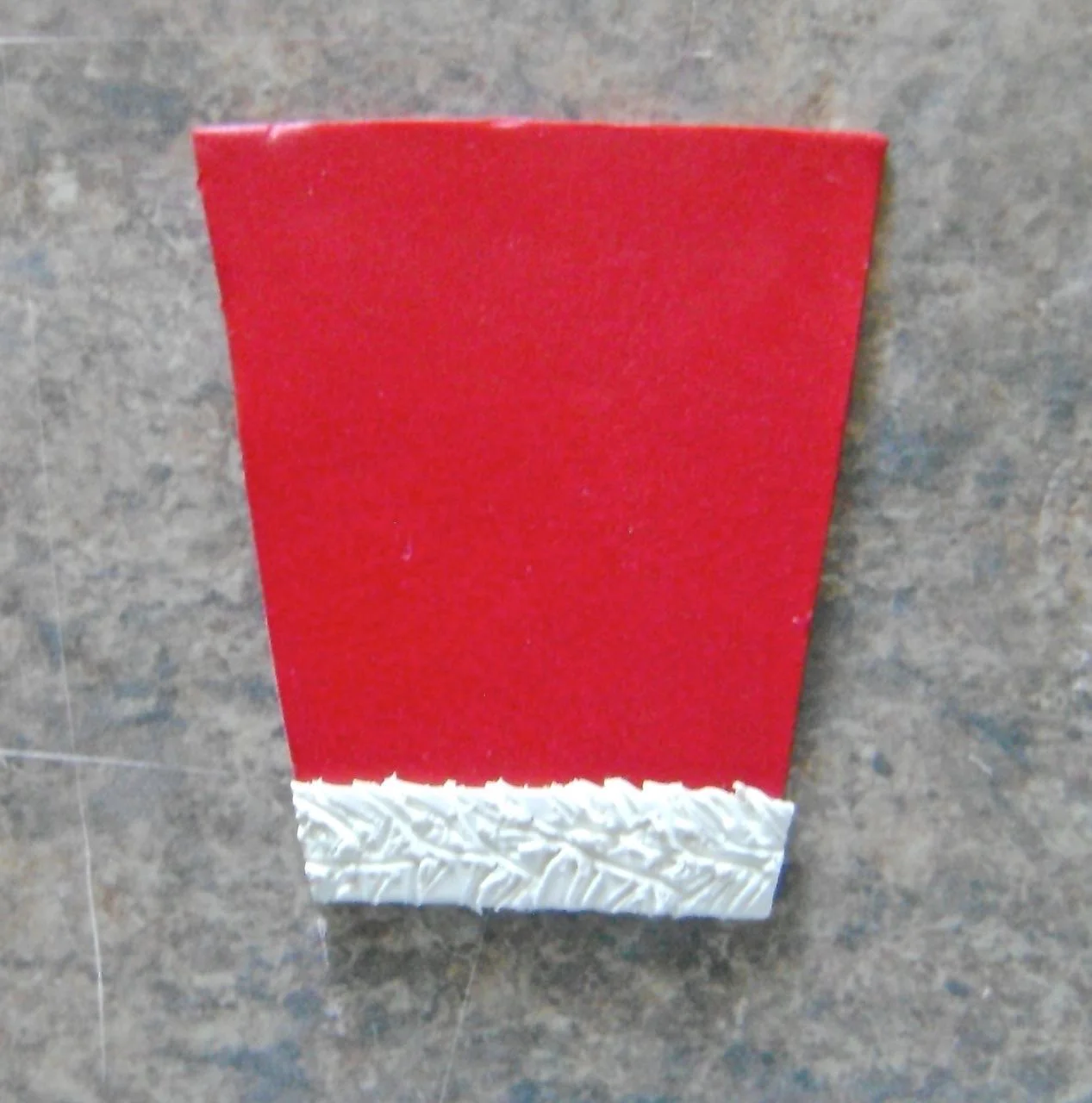 step 14 - Trim the white edges flush with the red clay on the sleeve cuff.