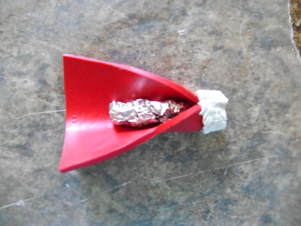 step 15 - Press the white edges together to seal them and connect the sleeve edges. Lay a loosely rolled piece of aluminum foil inside the sleeve. Pinch the sleeve seam together. The foil will remain in the sleeve permanently and allow you to shape it.