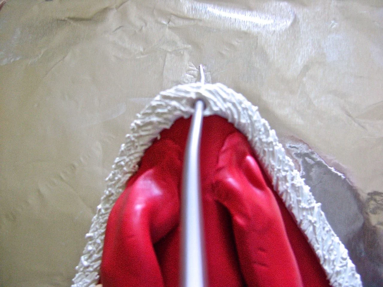 step 18 - Use an Etch ‘n Pearl tool to make a hole in the top center of the white clay to accommodate a hanger.