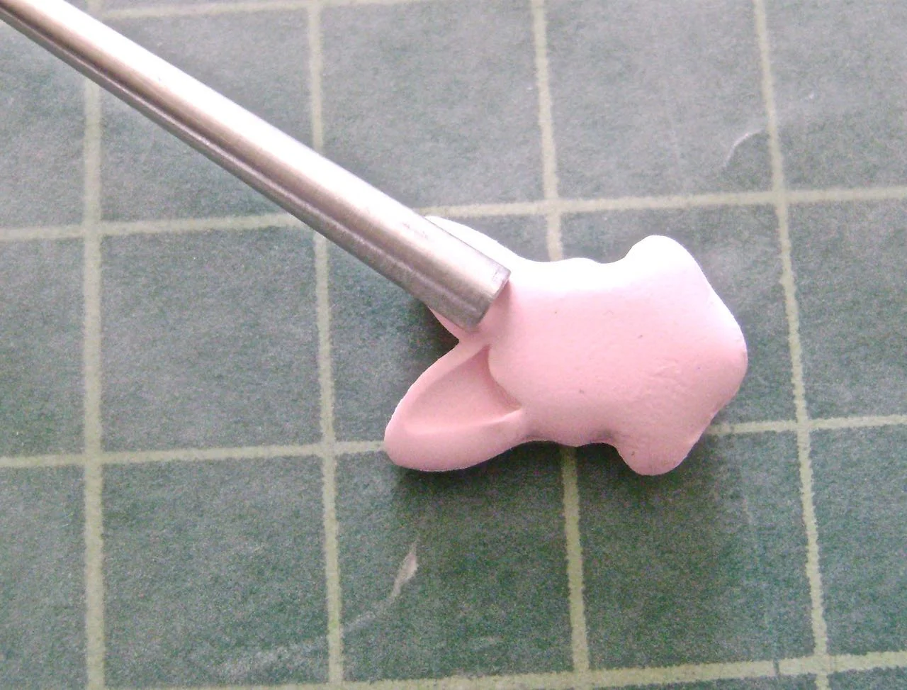 step 8 - Gently press a small Etch n' Pearl tool into the ears to give them dimension. Flip the bunny head over and do the same on the back side.