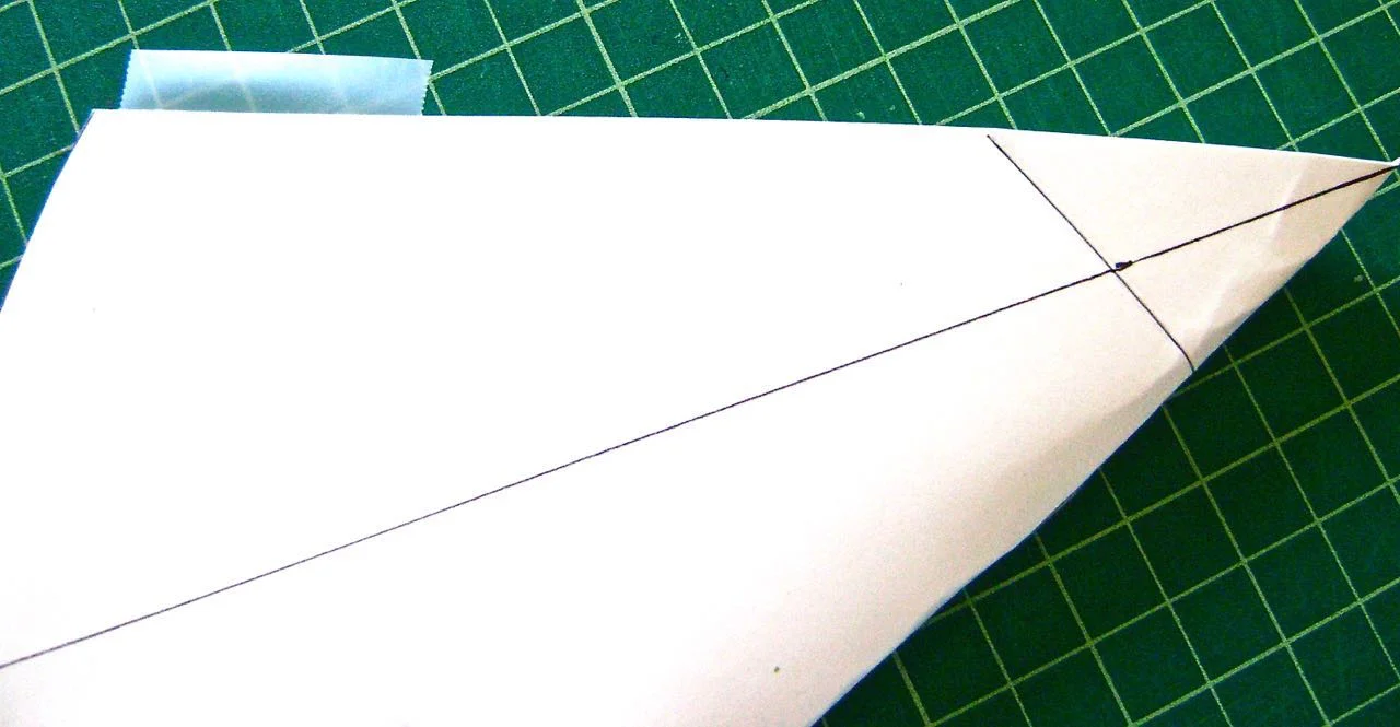 step 3 - Connect the back edges by placing pieces of transparent scotch tape along one back edge. Match the two edges and fold the tape over to catch the second edge.