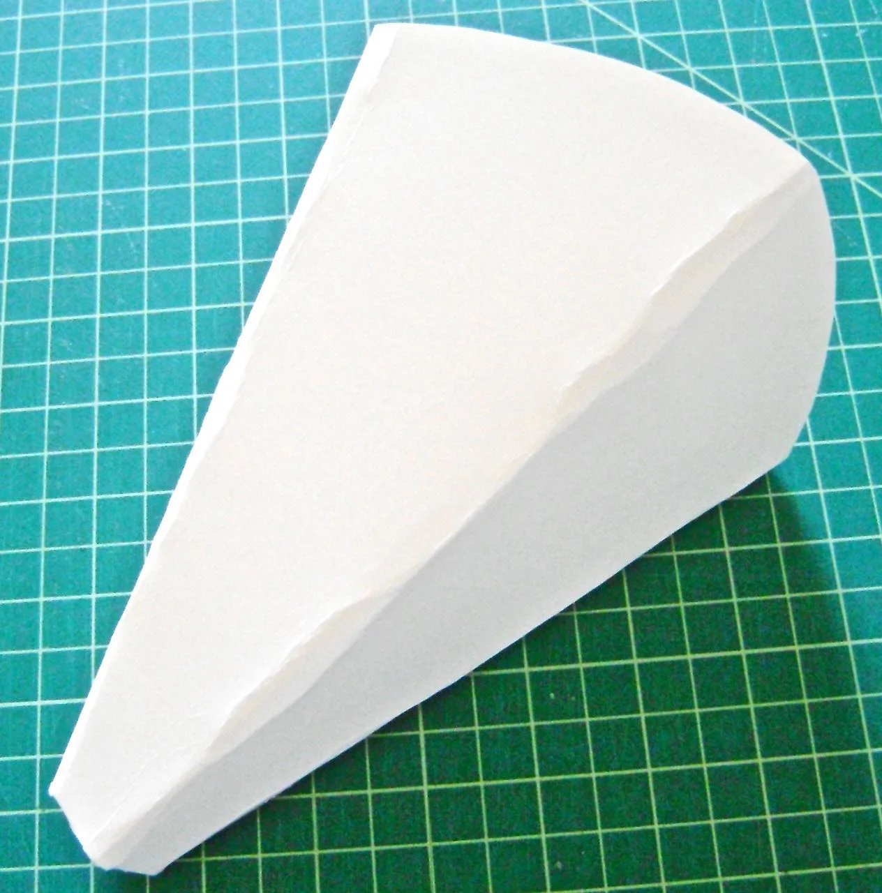 step 4 - Press the mold cone sides flat with the center front and center back aligned, but do not crease the sides. The finished sconce should not be a round cone shape like a party hat but more a party hat that has been flattened a bit.