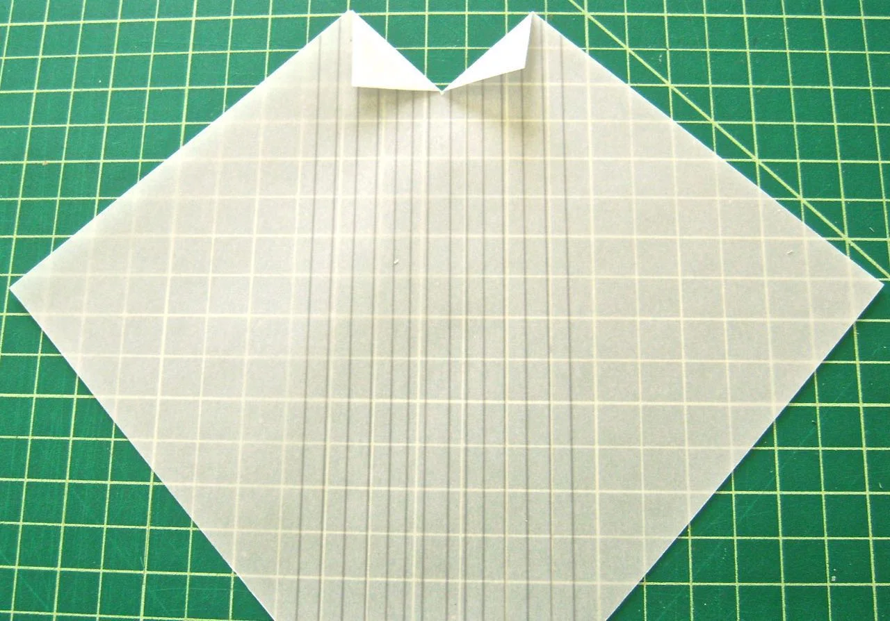 step 3 - Create the tux shirt collar by making a 1’ slit in the vertical center of the shirt. Fold the slit pieces into triangles.